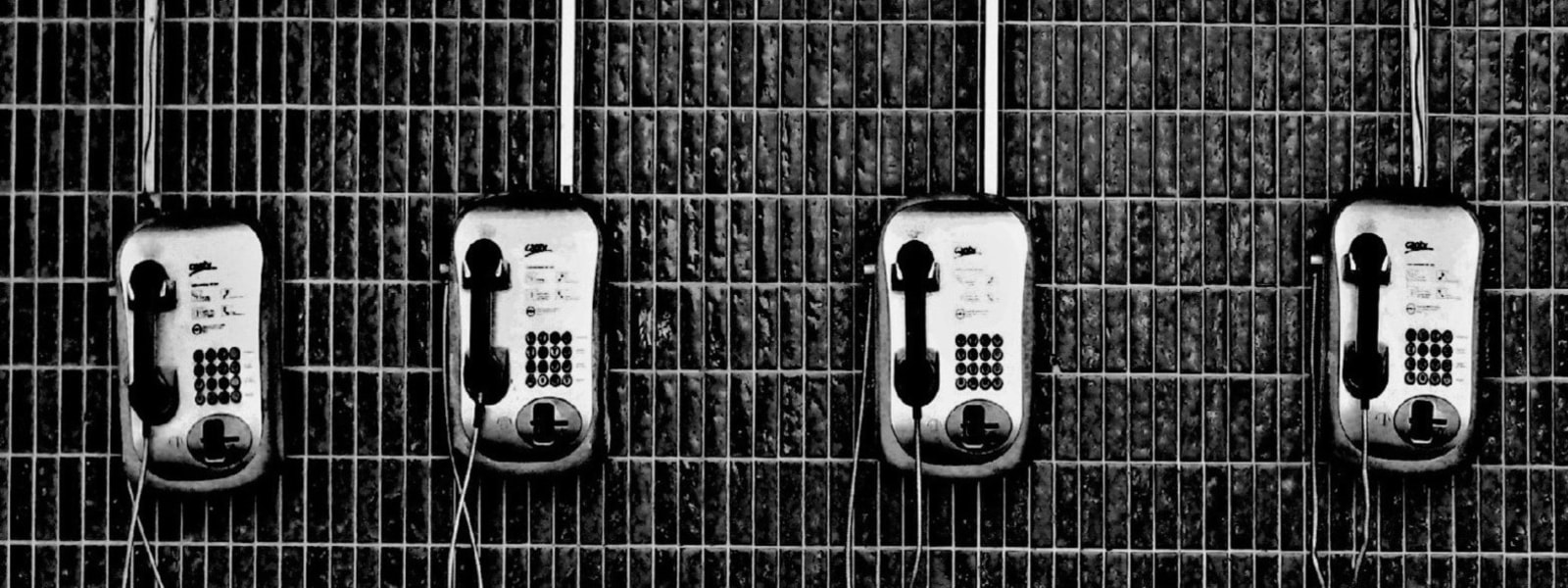 4 phones hanging in a line